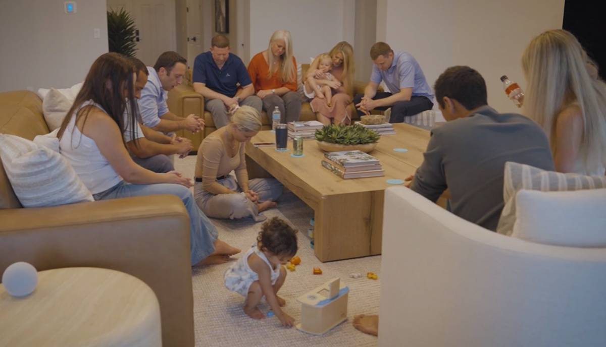 A group of people that are part of a giving circle praying together.